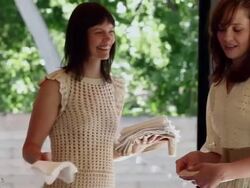 MS TU two sisters setting table for dinner on front porch of home Stock Footage