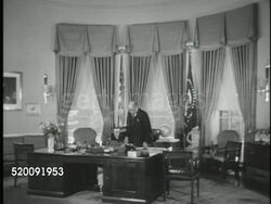 1948: WASHINGTON, D.C.: THE WHITE HOUSE: WS Executive Wing reception area w/ man at desk & male staff member, desk man greeting unidentified man w/ briefcase. VS Oval Office, staff member arranging desk, VS President Harry S Truman tidy desk top. Instructional Video