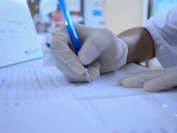 Scientist writing notebook in laboratory Stock Footage