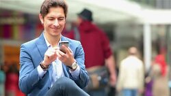 Young businessman texting in the city Stock Footage