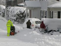 People snowblowing, shoveling and digging out cars after big storm Stock Footage
