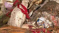 Piles of plastic bags and other trash litter a street. Stock Footage