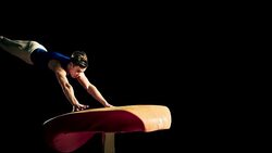 SLO MO Male gymnast performing front handspring on vault Stock Footage