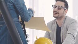 Business colleagues reviewing blueprints Stock Footage