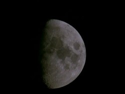CU 3/4 moon rising, waxing gibbous phase Stock Footage