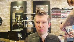 Male Hair stylist cutting male clients hair Stock Footage