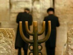 MS, two men praying facing Wailing Wall, menorah in foreground, Jerusalem, Israel Stock Footage