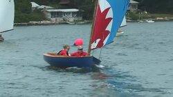 A father and daughter team round the mark while racing in the Beetle Cat Class Championship Regatta. Stock Footage