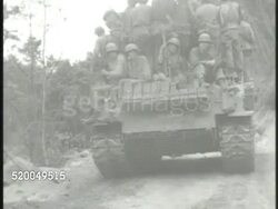 1951: KOREAN WAR: U.N. FORCES: VS United States Marines (7th Infantry Division) riding on top of M4 Sherman tanks moving along roads. VS Ethiopian National Defense Force soldiers riding Jeeps. VS Armed Forced of Philippines (AFP) soldiers fighting. Instructional Video