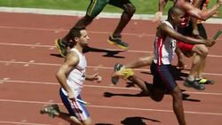 Male relay runners racing on track Stock Footage
