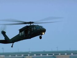 Wide shot Blackhawk helicopter approaching and landing at New Orleans International Airport / Louisiana Stock Footage