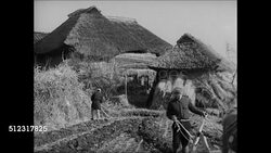 1939: JAPAN FARM LIFE: WS Japanese farm lands hills houses. WS Japanese man plowing w/ cattle woman hoeing and huts BG. INT MS Family of farmers eating. MS Woman at stove stone pot. VS Pouring drinking tea smoking pipe. Instructional Video