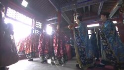 Taoist monks walk single file through a temple. Stock Footage