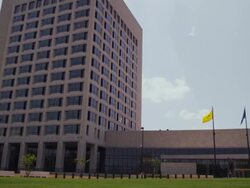Wide shot Federal Reserve Bank of Kansas City municipal building with flags Stock Footage