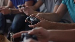 Guys sitting on couch playing video games Stock Footage