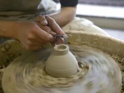 CU Shot of female potter are sharpened bowl with pottery wheel in studio / Kyoto, Japan Stock Footage
