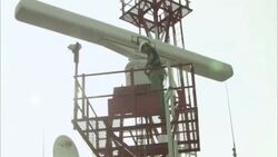 A technician carefully climbs down a metal radar tower. Stock Footage