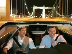 MS POV Two young man driving in modern converrtible car laughing and smiling at night in urban area / Minneapolis, Minnesota, United States Stock Footage