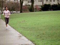 WS PAN Woman jogging on sidewalk / Portland, OR, USA Stock Footage