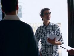 MS PAN Group of coworkers standing in discussion at workstation in office/Washington, USA Stock Footage