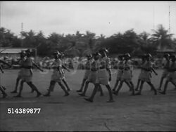 1953: VISITING REMOTE VILLAGES: TUKAI: VS Honour Guard of King's African Rifles (KAR) parading in formation, CU Unidentified soldier, VS British High Commissioner General Sir Gerald Templer reviewing small group. Commonwealth, protection. Instructional Video