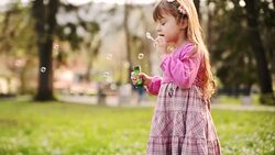 Girl blowing bubbles Stock Footage