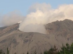 Timelapse wide shot of steam erupting from volcanic crater in dawn light, Japan Stock Footage