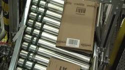 Staff working in a busy Amazon warehouse on Black Friday News Clip