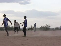 Refugee children playing soccer Stock Footage