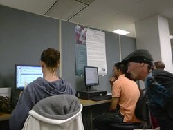 MS Man sitting down with other job seekers working on computers at state run job center / Jackson, Michigan, United States  Stock Footage