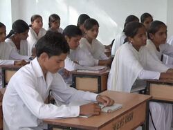 MS Boys and girls in white uniforms and a minimalist classroom study intently / Himachal Pradesh, India Stock Footage