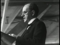 President Calvin Coolidge speak from a podium. News Clip