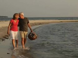 MS, PAN, Married Couple Walking Together on Beach, Eastville, Virginia, USA Stock Footage