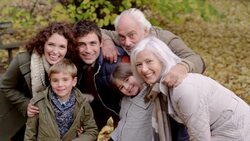 Multi-generational family standing in woods together Stock Footage