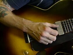 Craftsman 'Luthier' Nigel Forster making hand made Guitars Stock Footage