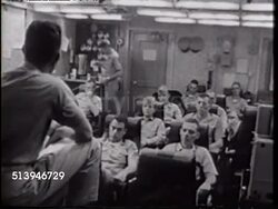 1965: USS ENTERPRISE (CVN-65) BRIEFING: WS BEHIND Commander 'Skipper' Otto E. Krueger SOT speaking to pilots of VA-94 'The Shrikes' in briefing room, VS Commander Krueger & pilots listening. Cold War, conflict, combat cruise. Instructional Video