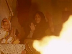 Mauritanian people in their tent singing at night at fireplace Stock Footage