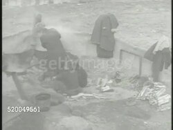 1951: KOREAN WAR: WAR TORN: VS Demolished town, destroyed buildings, various Korean refugees living in war torn town, chiseling brick. Instructional Video