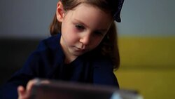 Little cute girl using tablet PC Stock Footage