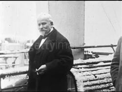 1920s: MEDICINE: MS French psychologist, pharmacist Emile Coue (1857-1926) dressed in coat & bowler hat standing on snowy ship's deck, CU Nodding, speaking (No SOT).   Coue method, psychotherapy, auto-suggestion, self-hypnosis. Instructional Video