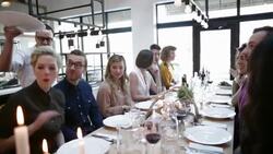 Waiter serving friends at large restaurant table Stock Footage