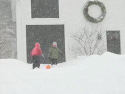 MS Boy and girl playing soccer ball during snowstorm / Yarmouth, Maine, USA Stock Footage