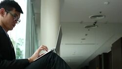 Businessman Sitting on floor and working with Laptop in office Stock Footage