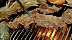 meat flame broiled on a barbecue Stock Footage
