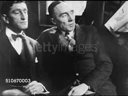 1920s: CRIME: HA WS People walking in street, Prohibition-era criminal & co-leader of Dutch Anderson gang Gerald Chapman sitting w/ unidentified man, being escorted alone to police wagon.   Murder, police, capital punishment, death sentence. Instructional Video