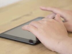 Using tablet on table Stock Footage