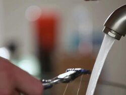 CU Rinsing off Razor in sink / Los Angeles, California, United States Stock Footage