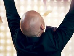 Man with money in front of lightwall Stock Footage