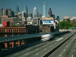 Time lapse, Philadelphia cityscape, commuter traffic races across Ben Franklin Bridge. Stock Footage