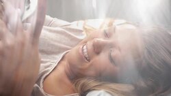 People waking up - Young Woman Texting in Bed Stock Footage